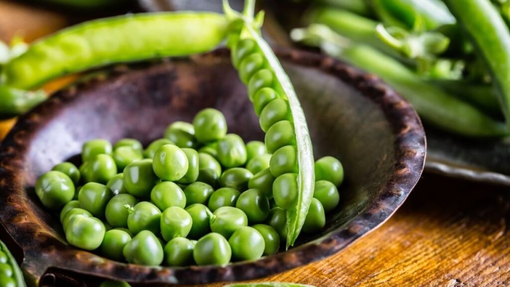 Fresh or frozen peas (no added salt), a fiber and protein-rich treat for dogs. 