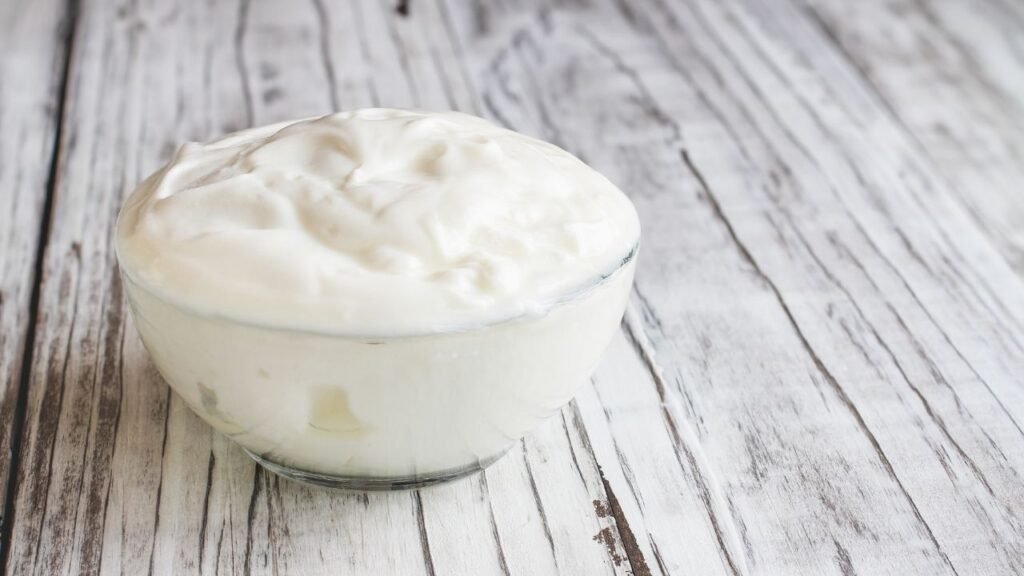 Plain yogurt, a probiotic-rich dairy option that aids digestive health in dogs.